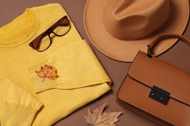 Photo of Flat lay composition with stylish hat on brown background