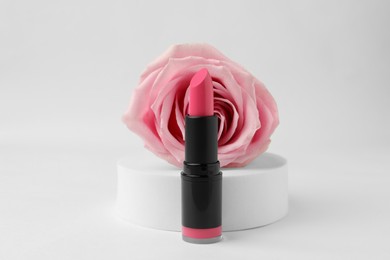 Photo of Beautiful pink lipstick and rose on white background