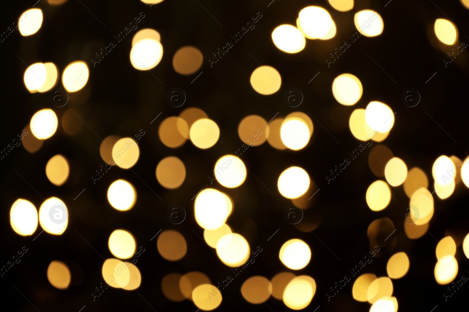 Photo of Blurred view of beautiful lights on black background. Bokeh effect