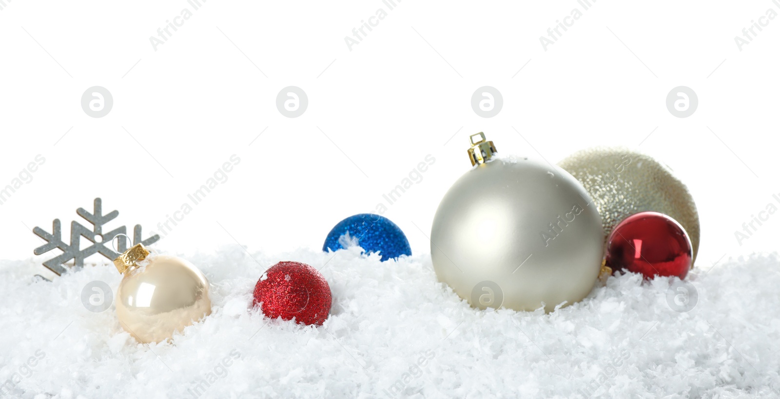 Photo of Christmas decoration on snow against white background