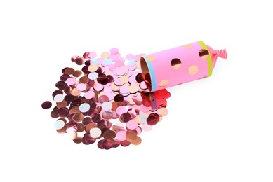 Photo of Colorful confetti with pink party cracker isolated on white