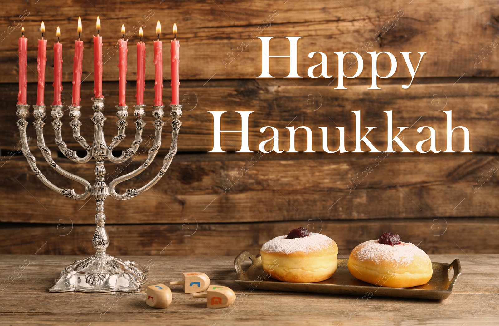 Image of Happy Hanukkah. Silver menorah, sufganiyot and dreidels on wooden background
