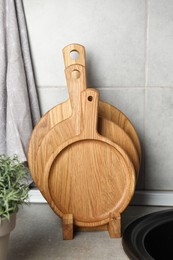Photo of Wooden cutting boards on light grey countertop in kitchen