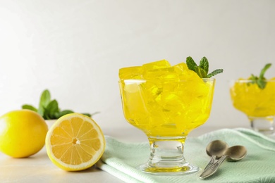 Dessert bowl with tasty jelly cubes served on table. Space for text