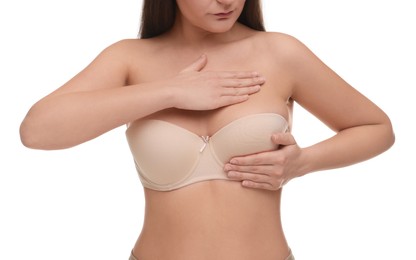 Photo of Mammology. Woman in bra doing breast self-examination on white background, closeup