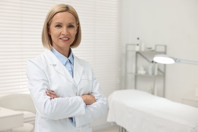 Photo of Portrait of happy dermatologist in modern clinic, space for text