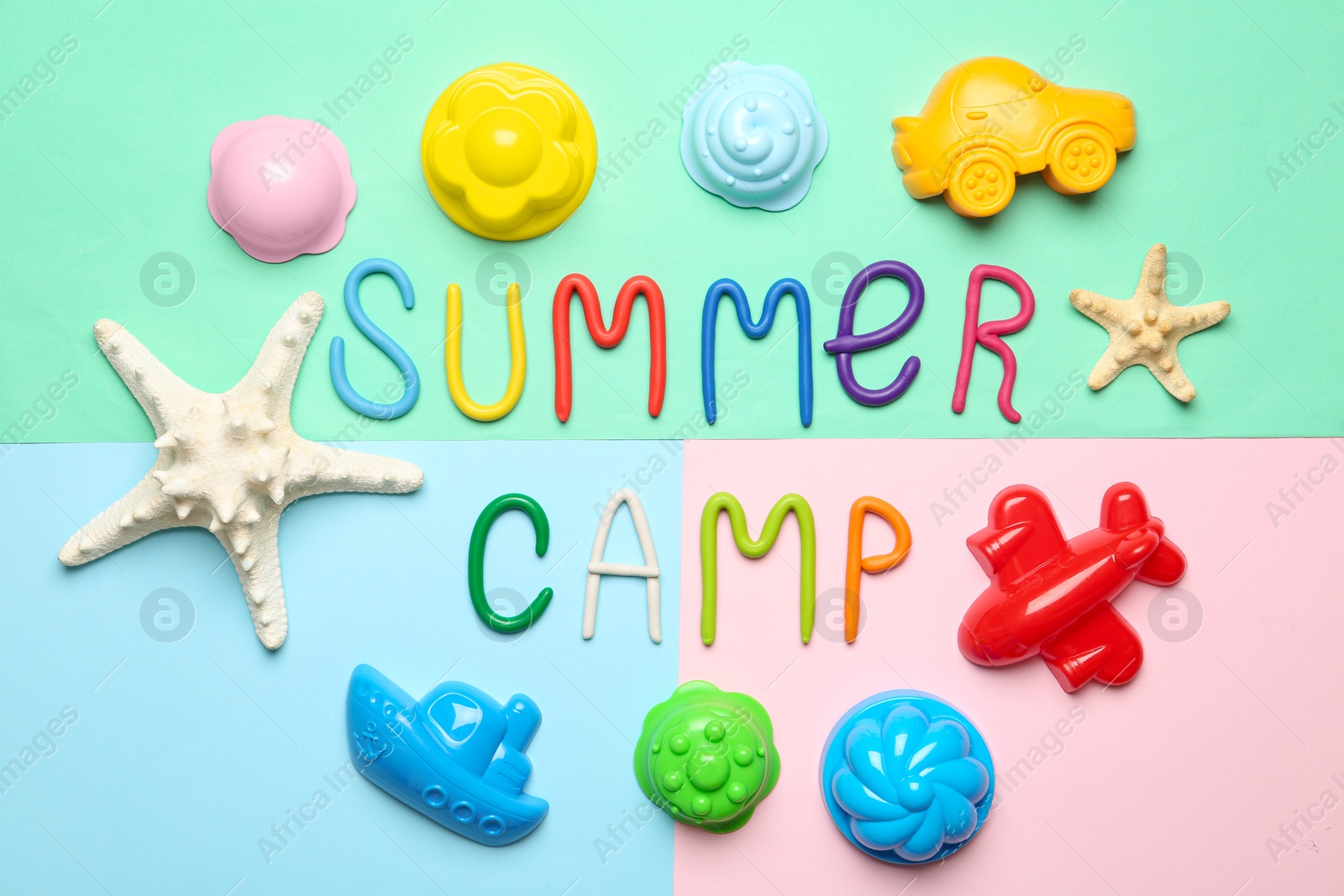 Photo of Flat lay composition with text SUMMER CAMP made of modelling clay on color background