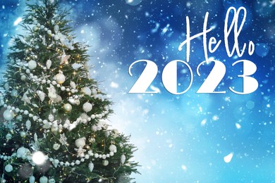 Hello 2023. Beautifully decorated Christmas tree on light blue background