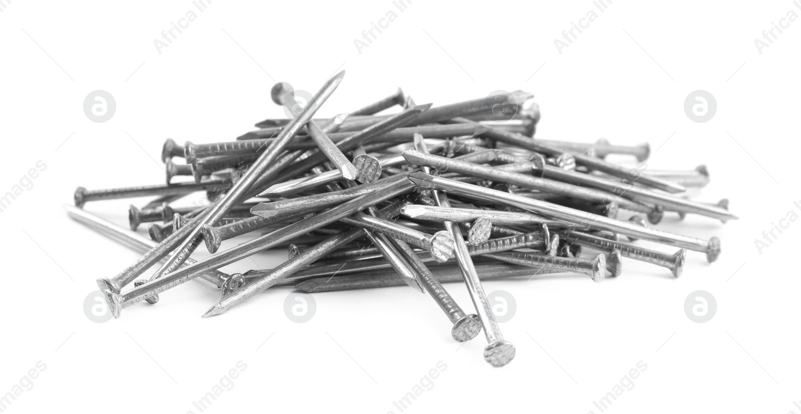 Photo of Pile of metal nails on white background