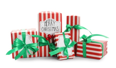 Photo of Christmas gift boxes with green bows and berries on white background