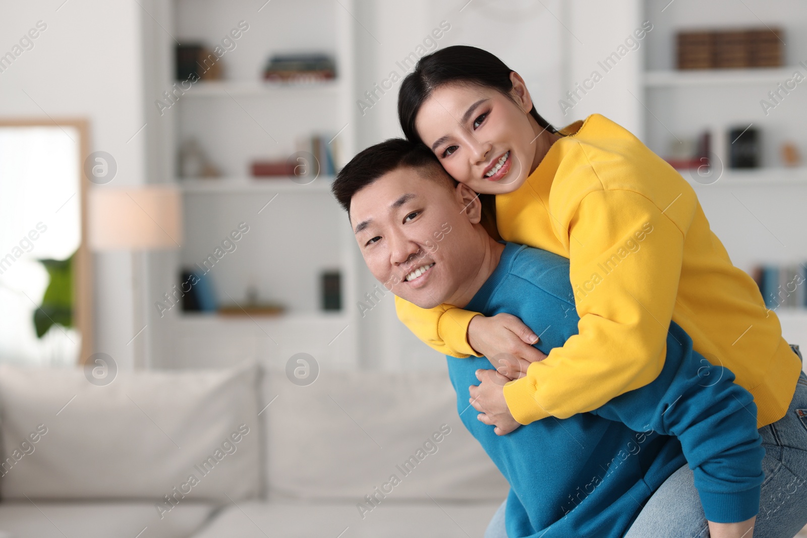 Photo of Happy couple spending time together at home, space for text