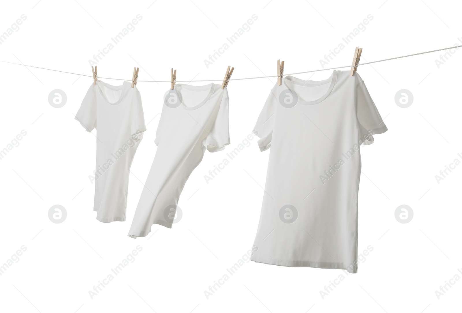 Photo of Many t-shirts drying on washing line isolated on white