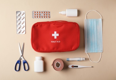 Photo of Flat lay composition with first aid kit on color background