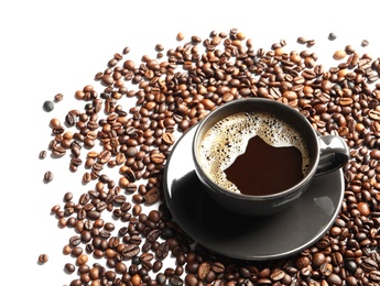 Roasted coffee beans and cup of hot beverage on white background