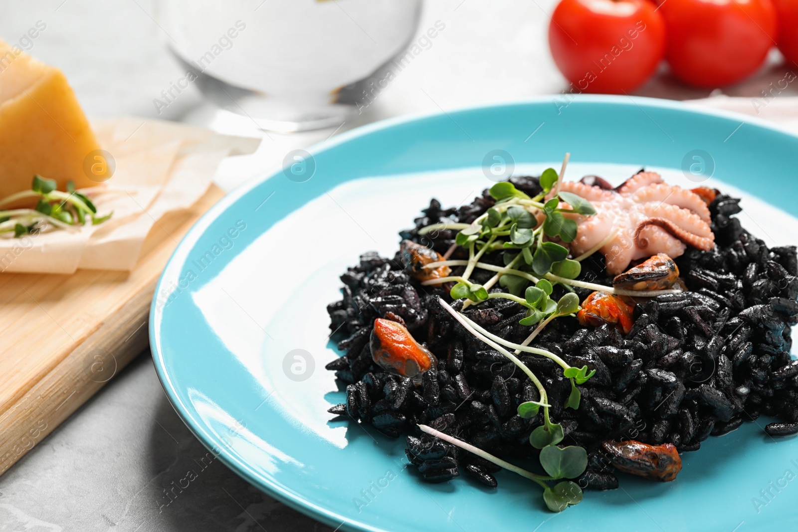 Photo of Delicious black risotto with seafood on table, closeup