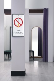 Sign No Smoking near dressing room in fashion store