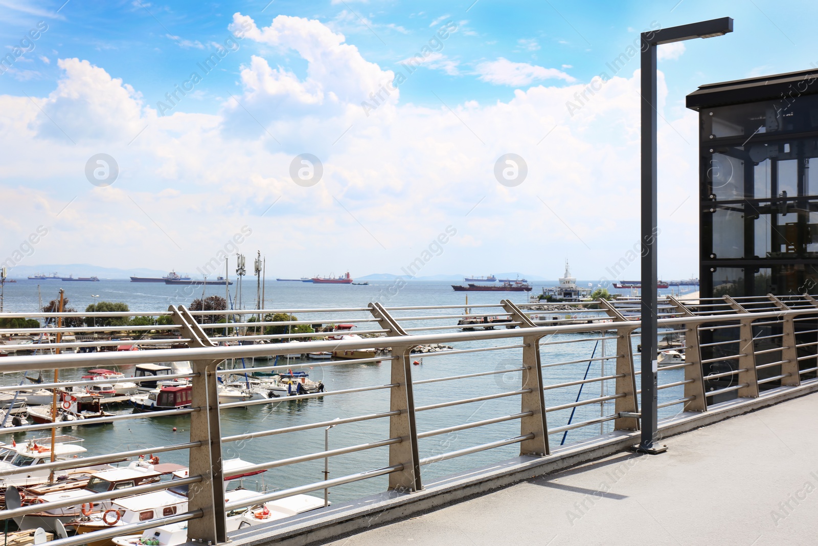 Photo of Modern boats at pier, view through railing