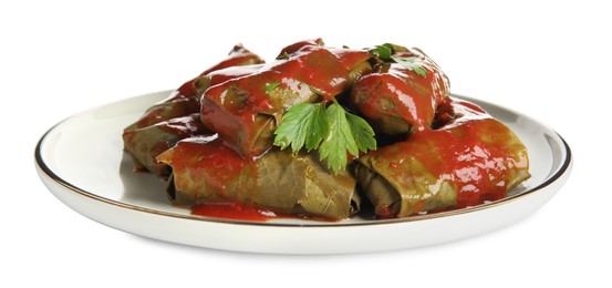 Photo of Delicious stuffed grape leaves with tomato sauce on white background