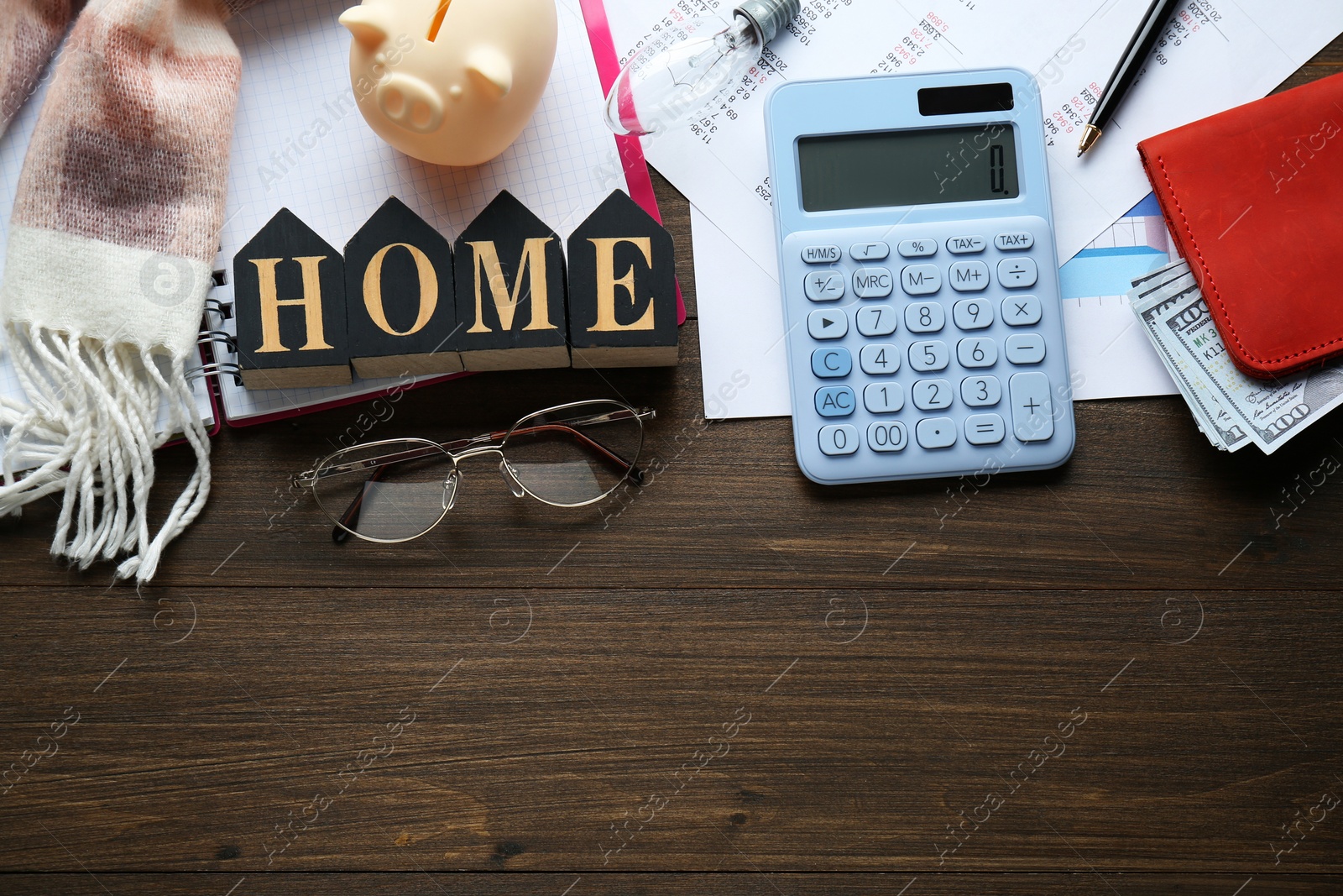 Photo of Flat lay composition with piggy bank and calculator on wooden table, space for text. Paying bills concept