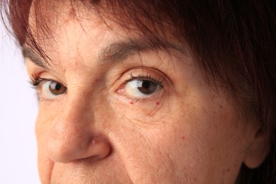 Closeup view of older woman on white background