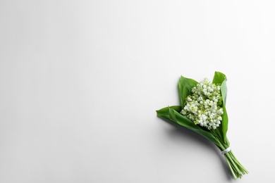 Beautiful lily of the valley bouquet on white background, top view. Space for text