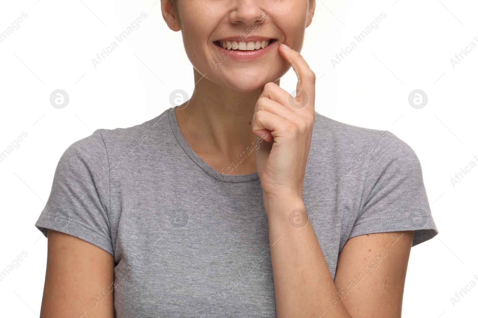 Photo of Woman showing her clean teeth and smiling on white background, closeup