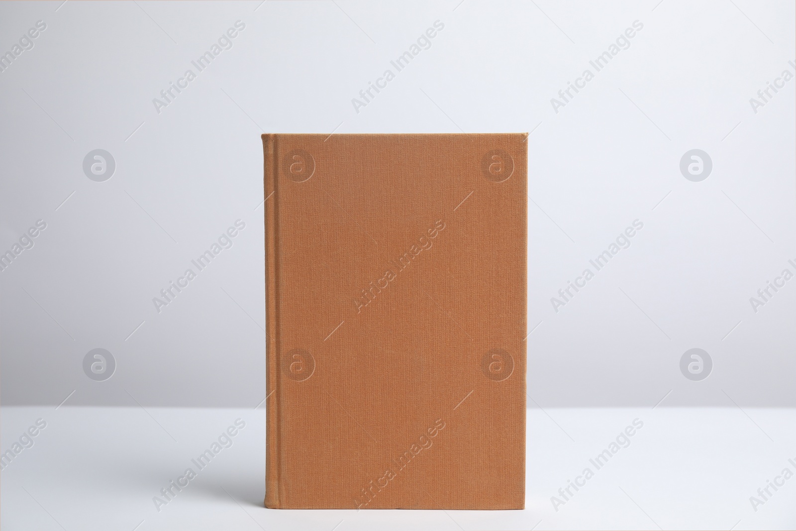 Photo of Hardcover book on white background. Space for design