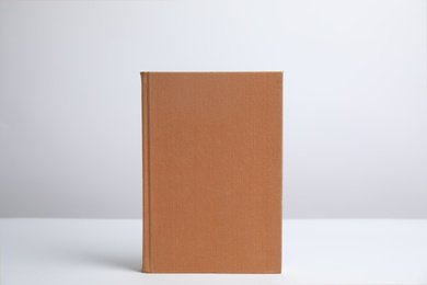 Hardcover book on white background. Space for design