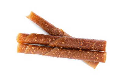 Delicious fruit leather rolls on white background, top view