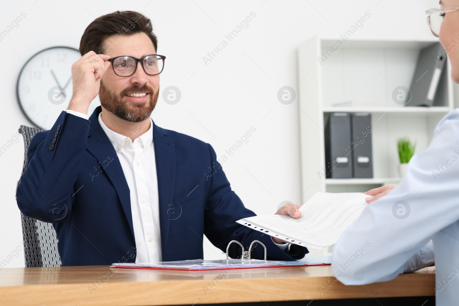 Photo of Businesspeople working with documents at table in office