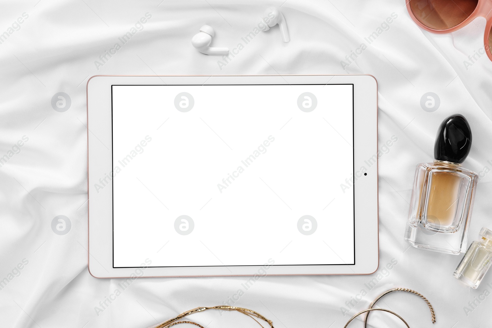 Photo of Flat lay composition with modern tablet on white fabric. Space for text