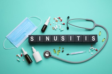 Photo of Black wooden cubes with word SINUSITIS, stethoscope, thermometer, medical mask and different drugs on turquoise background, flat lay