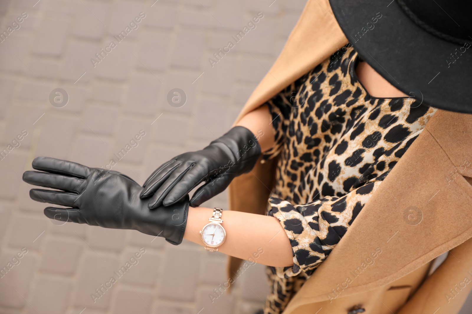 Photo of Young woman in stylish black leather gloves outdoors, above view