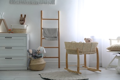 Photo of Cute children's room interior with wooden decorative ladder