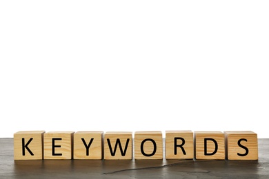 Photo of Wooden cubes with word KEYWORDS on grey table