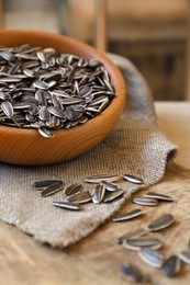 Photo of Organic sunflower seeds on wooden table, closeup