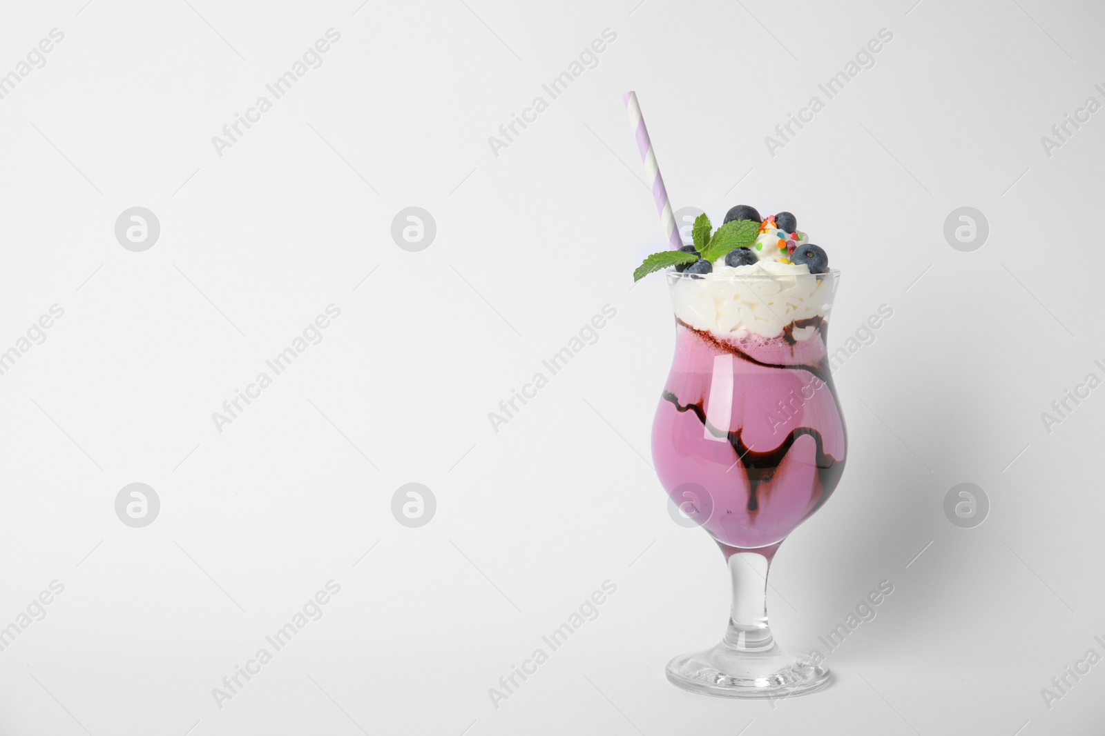 Photo of Glass of tasty milk shake on white background