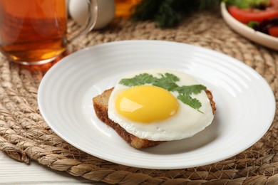 Delicious breakfast with fried egg served on white table, closeup