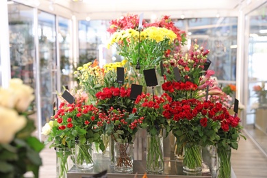 Photo of Assortment of beautiful flowers in shop. Florist's workplace