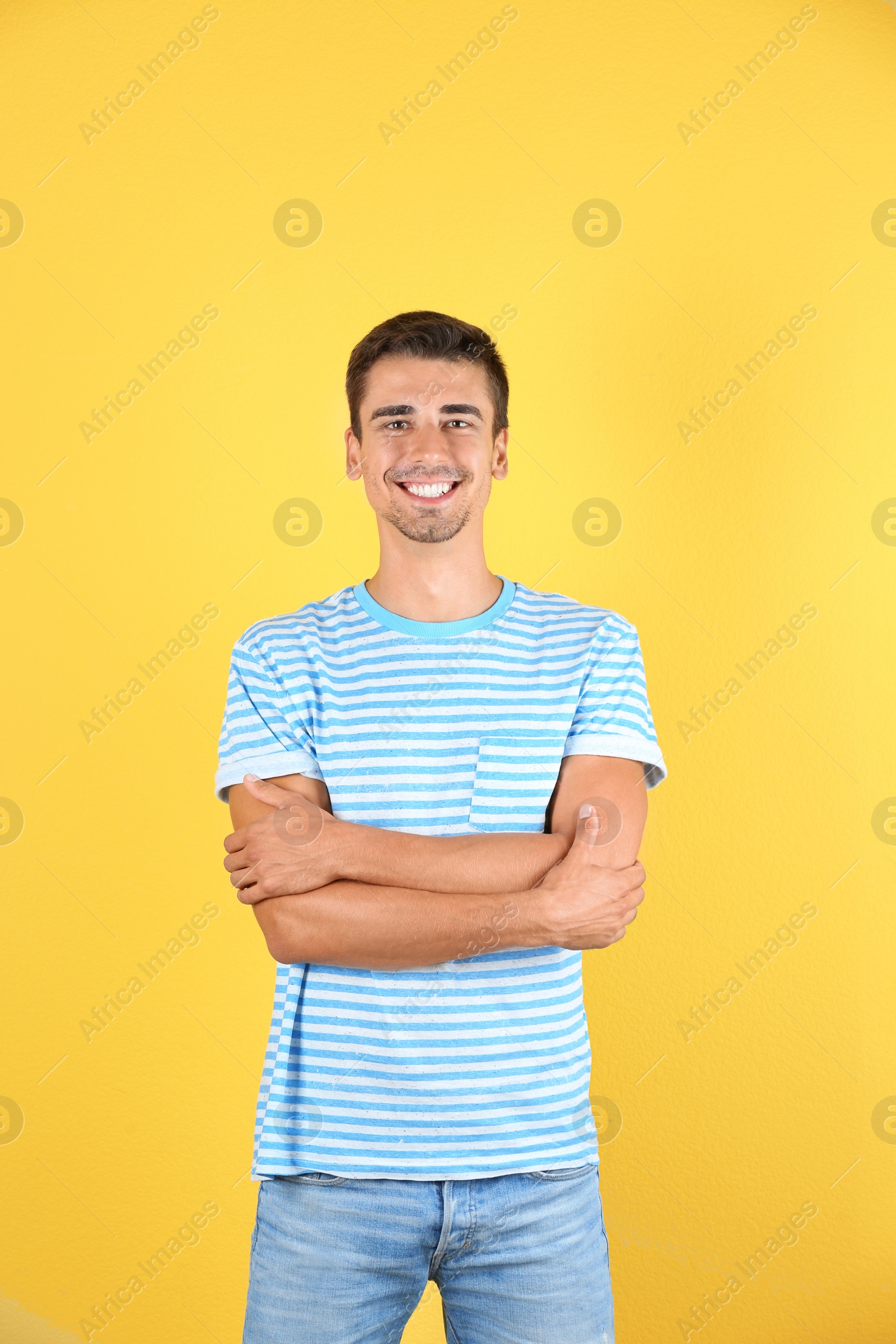 Photo of Portrait of handsome young man smiling on color background