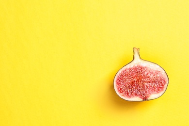 Half of ripe fig on color background, top view. Space for text