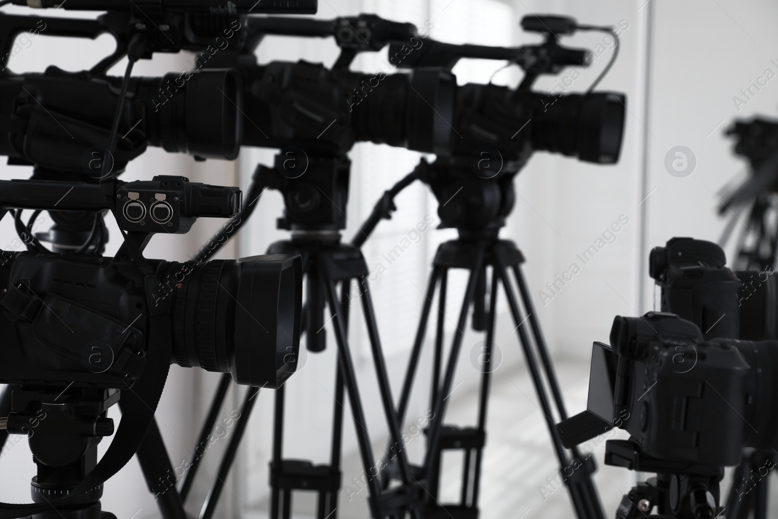 Photo of Modern video cameras indoors, closeup. Professional media equipment for broadcasting event