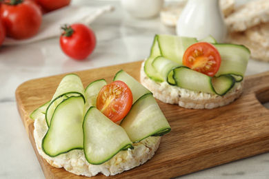 Photo of Puffed rice cakes with vegetables on table, closeup