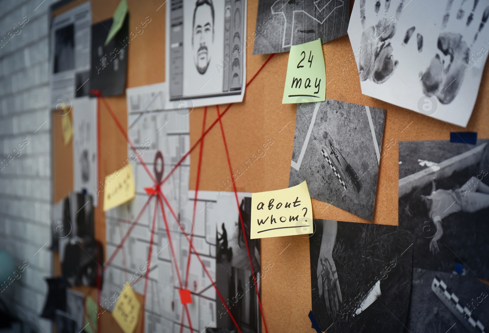 Photo of Detective board with stickers, crime scene photos and red threads, closeup