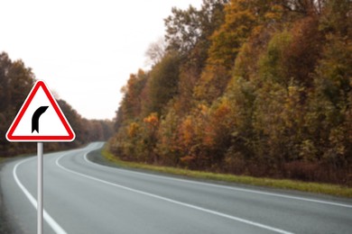 Image of Traffic sign BEND TO RIGHT near empty asphalt road in autumn