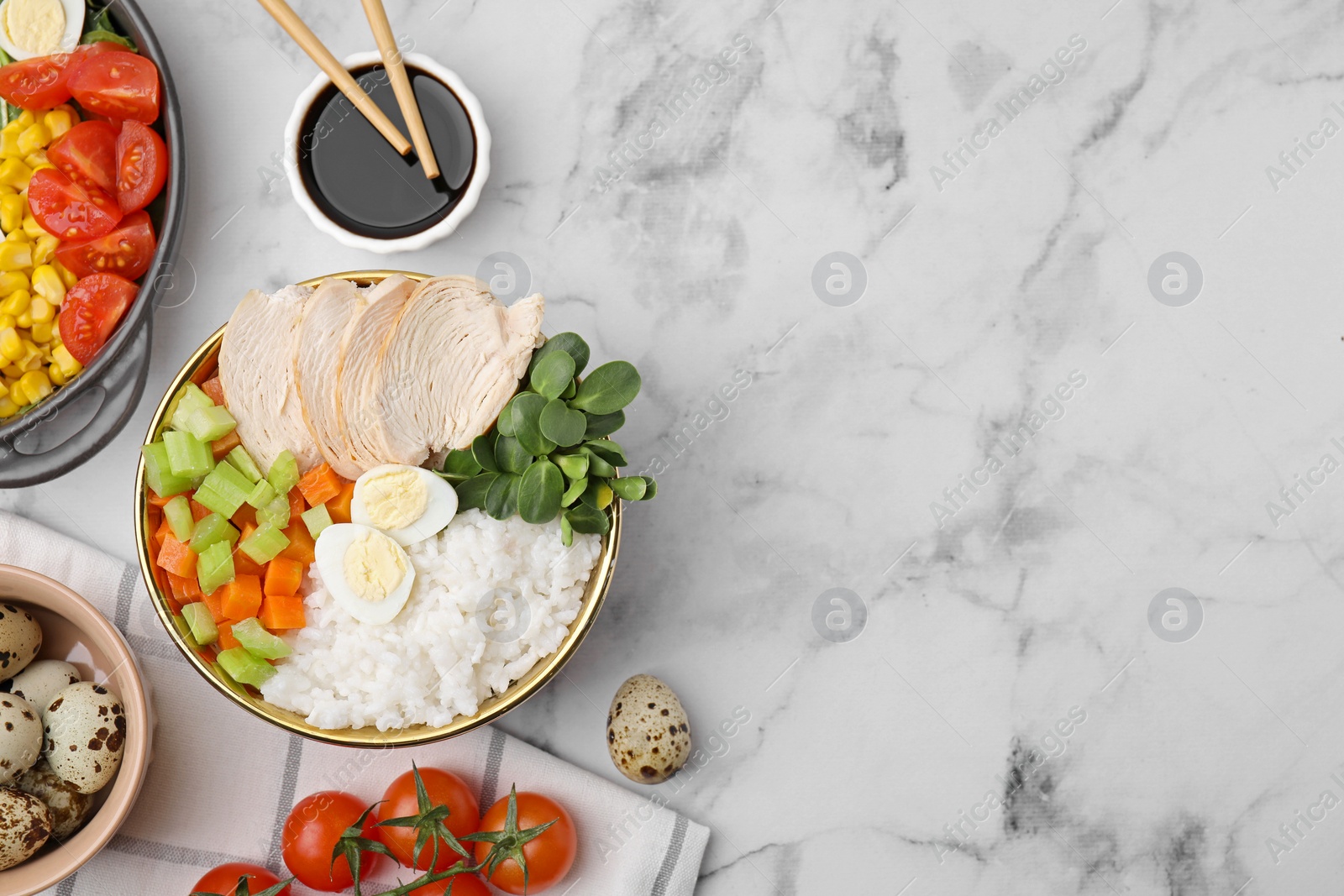 Photo of Delicious poke bowl of meat, egg, rice and vegetables served with soy sauce on white marble table, flat lay. Space for text