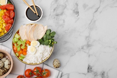 Delicious poke bowl of meat, egg, rice and vegetables served with soy sauce on white marble table, flat lay. Space for text
