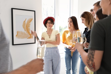 Photo of Group of people with guide at exhibition in art gallery