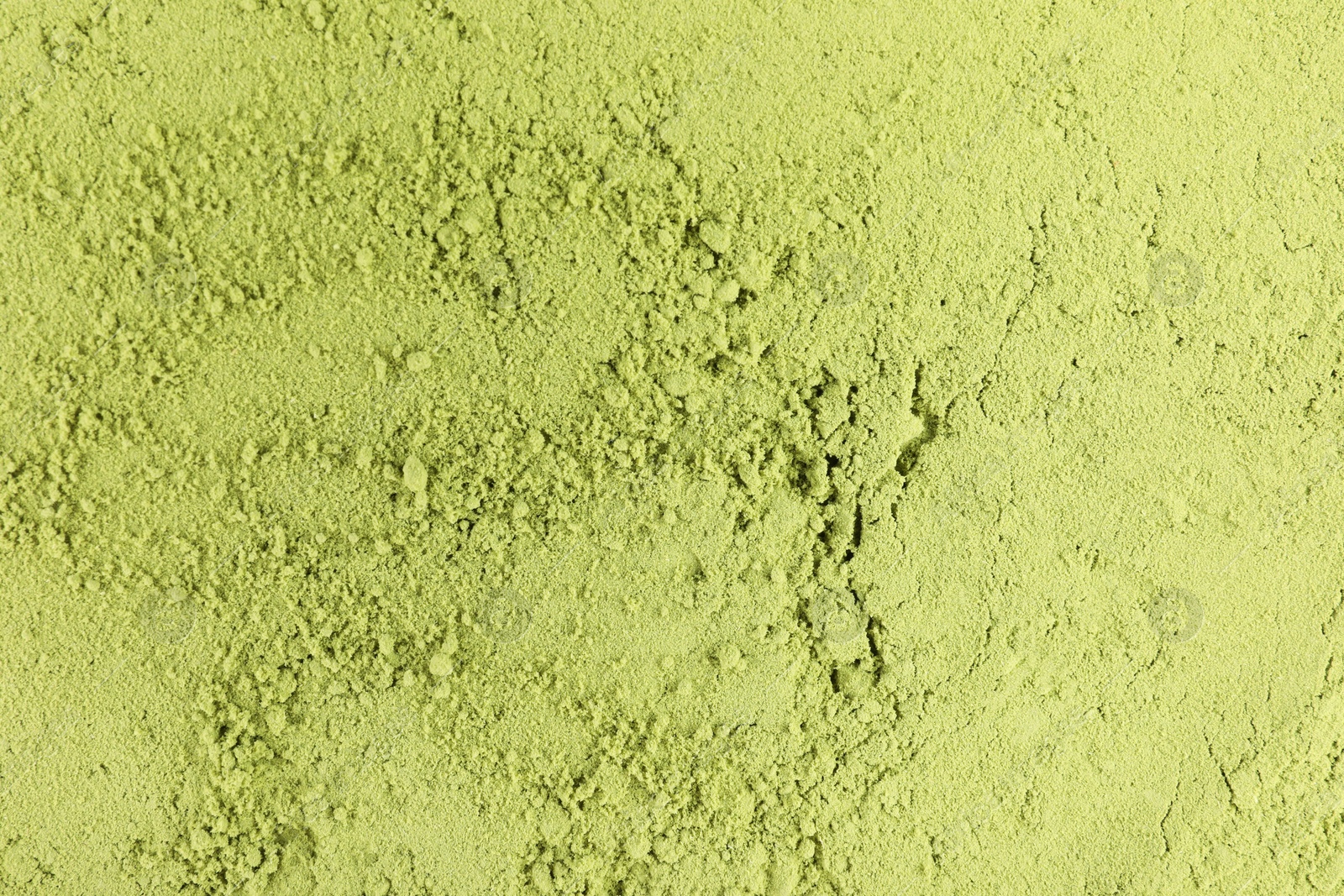 Photo of Green matcha powder as background, top view