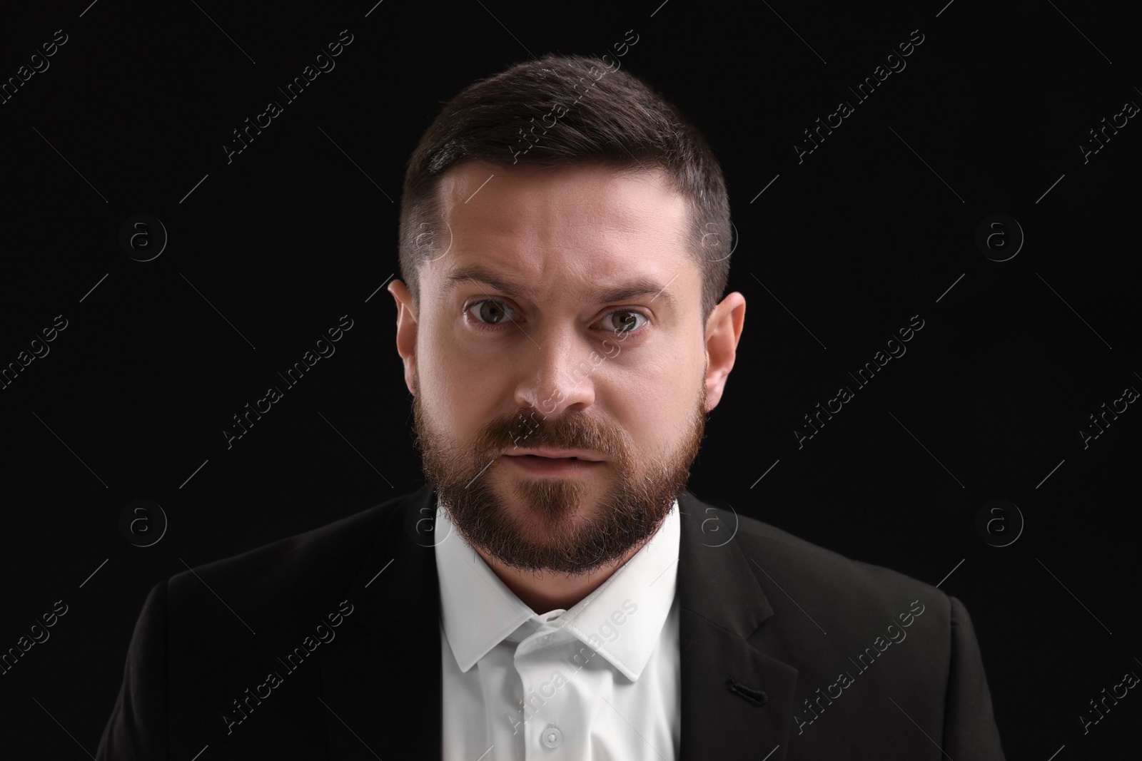 Photo of Personality concept. Angry man on black background